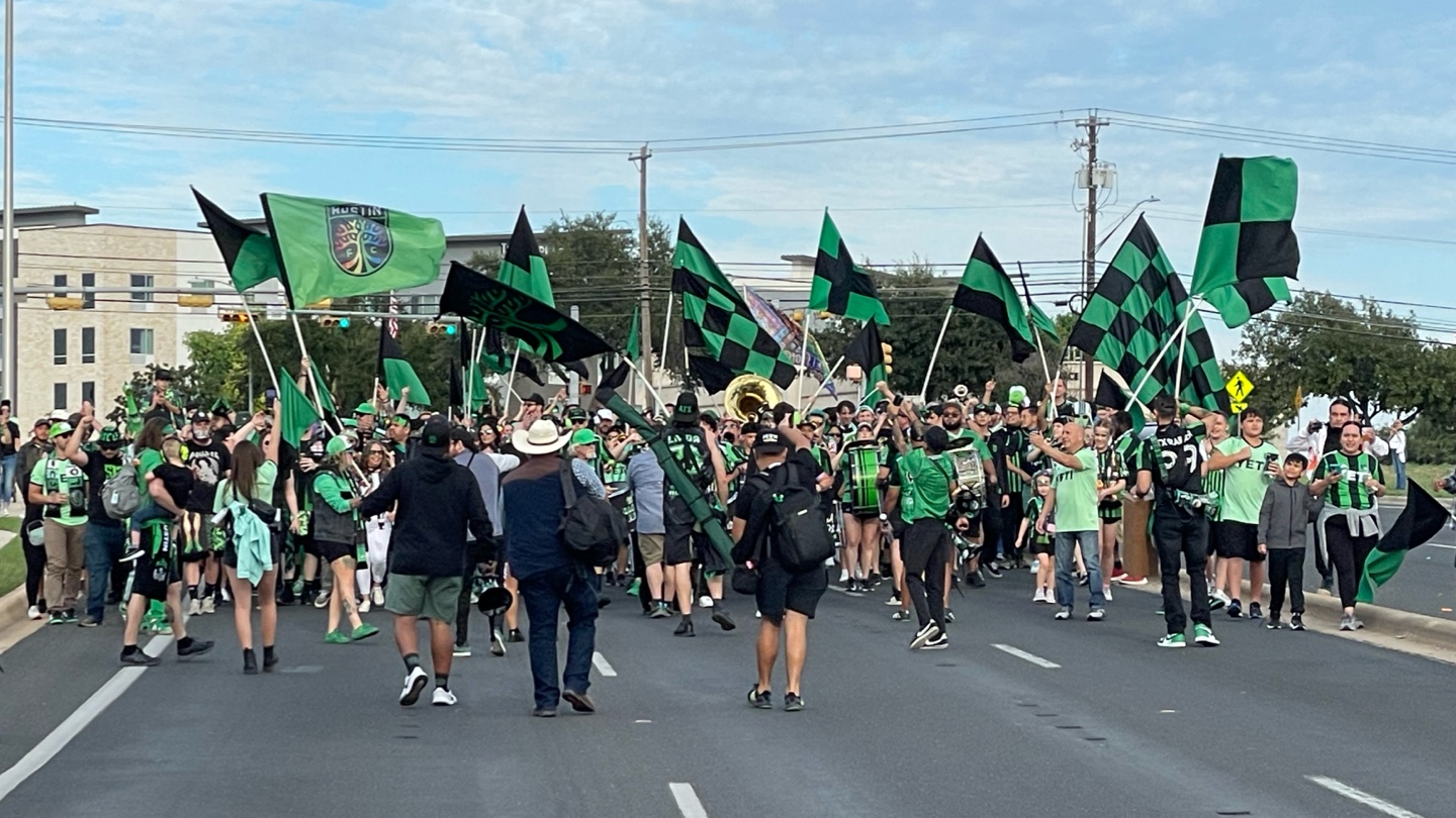 Supporters marching down the street before a match.