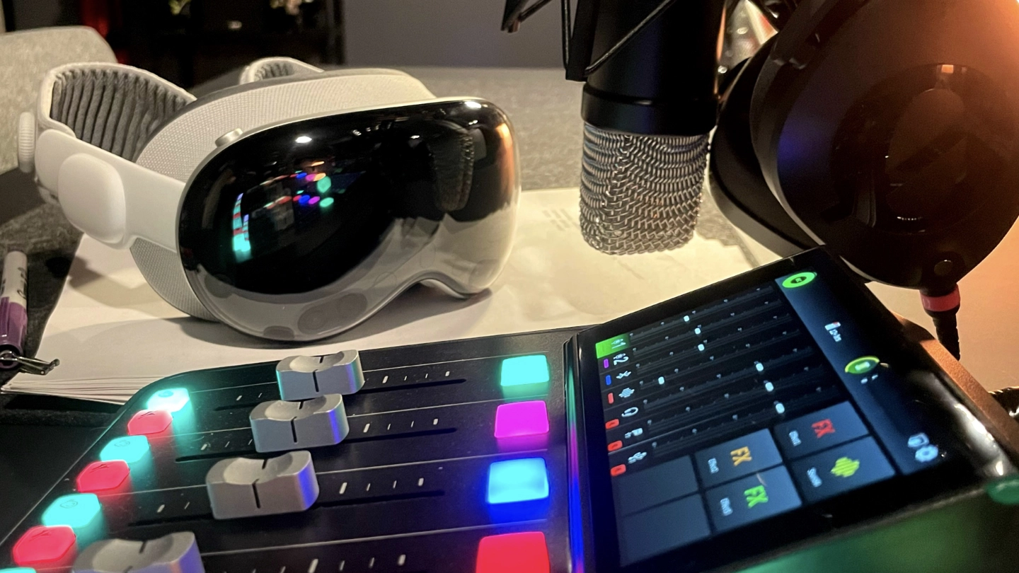 Image of a VR headset, a microphone, headphones, and a recording mixer.
